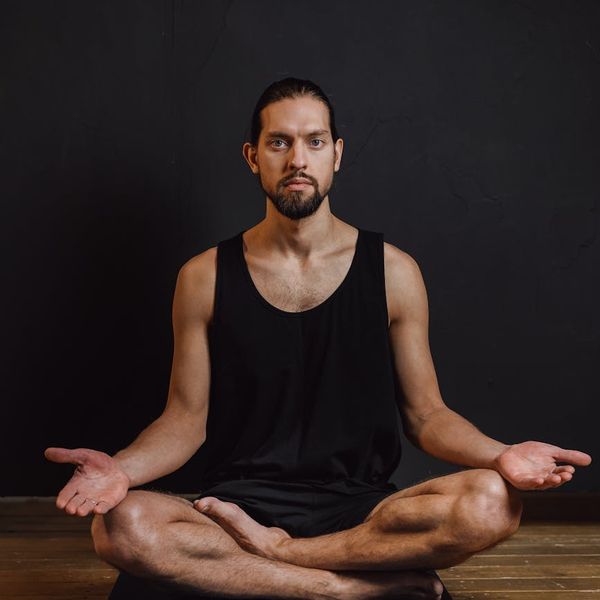Detailed view of a black yoga mat on dark floor