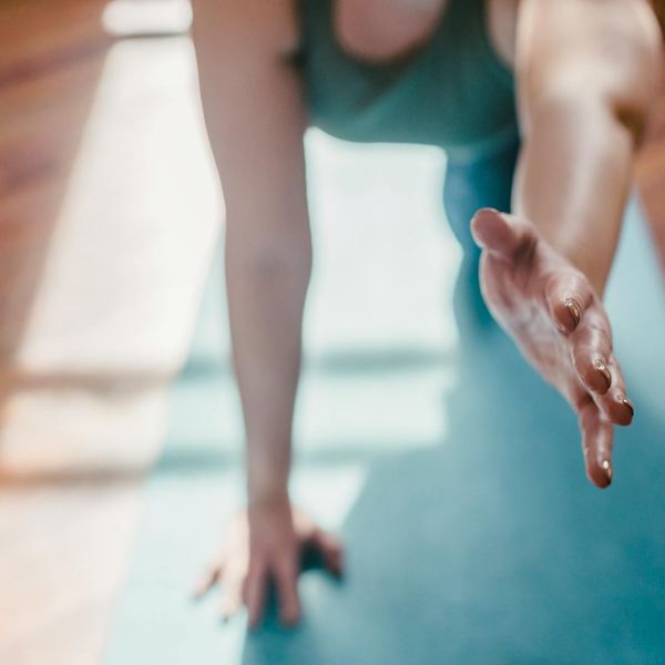 Person doing a stretching pose with focus on hands